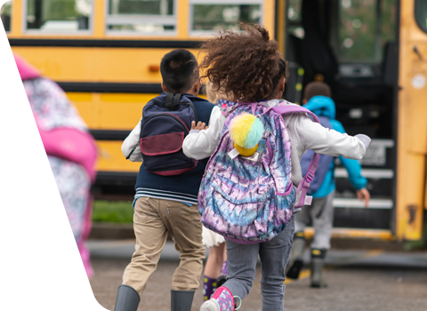 children running to school bus