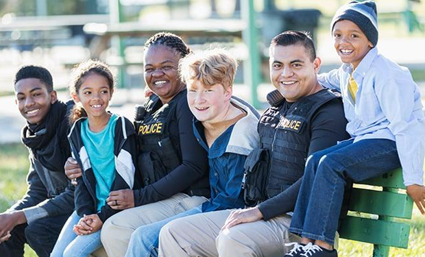 children with police officers at school